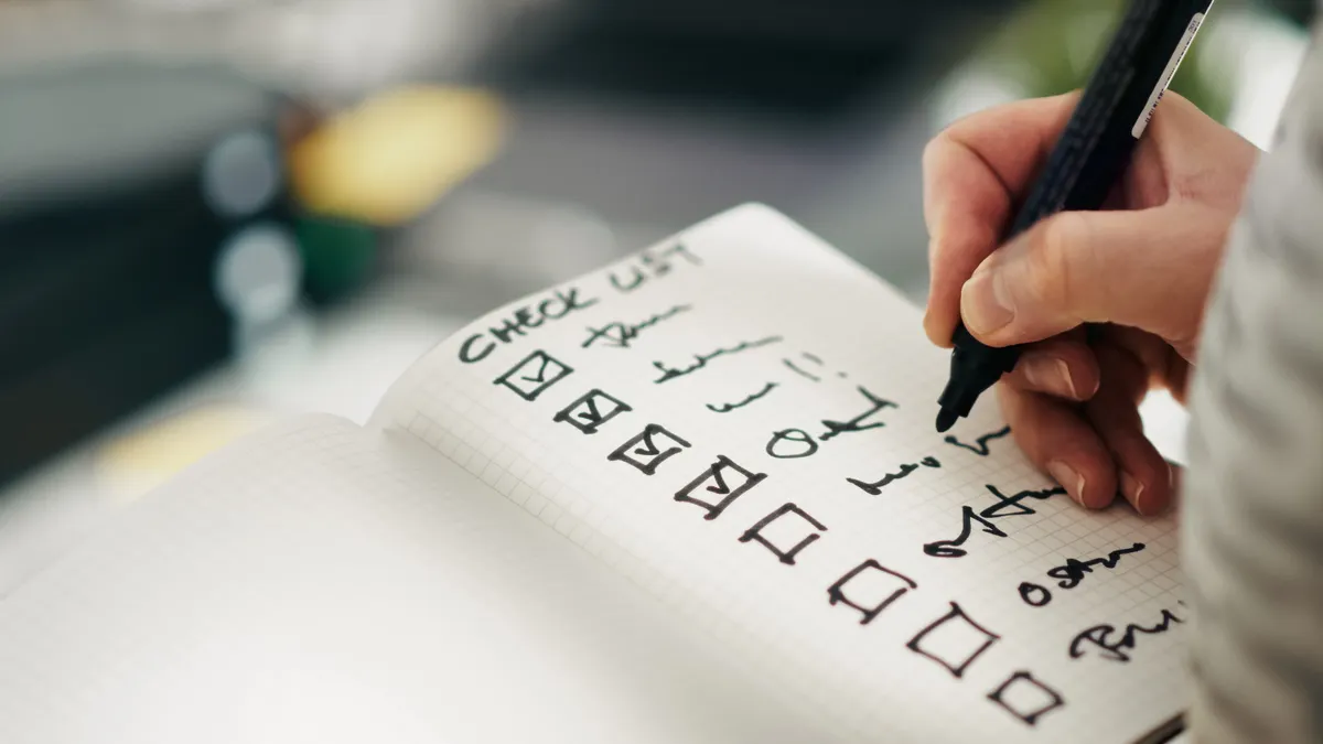 Editorial quality checklist for AI-generated copy: grammar, tone, accuracy, and citations — Close-up of a Hand Writing o