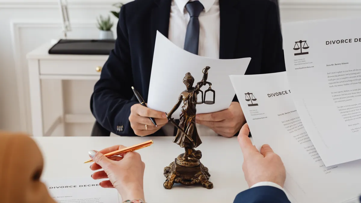 lawyer and client reviewing divorce papers at a desk