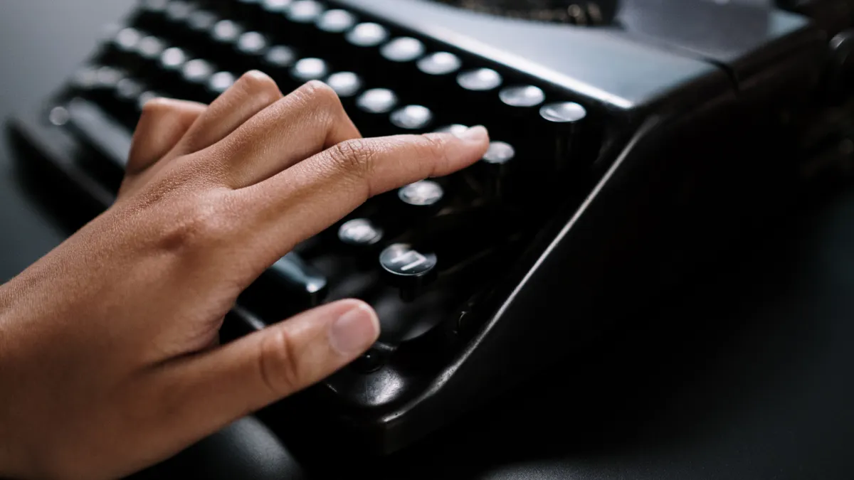 Onboarding and training playbook for authors adopting AI writing tools — Woman Writing on an Old Typing Machine