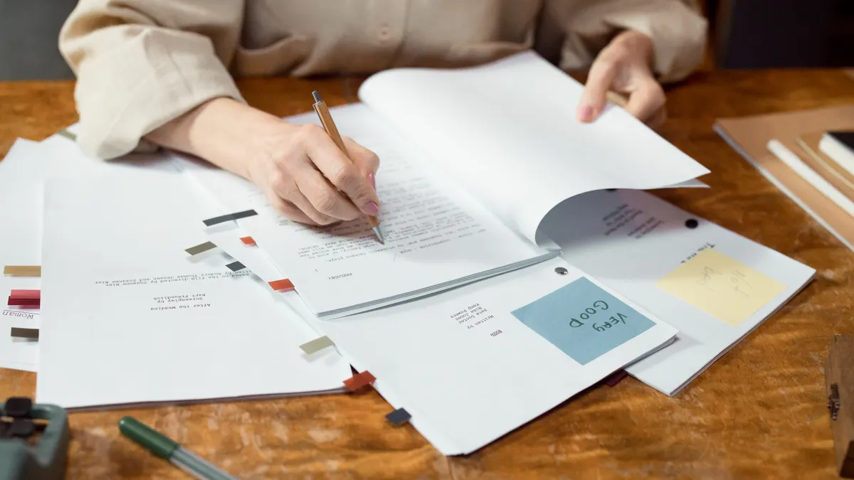 Onboarding and training playbook for authors adopting AI writing tools — Person Writing on White Paper